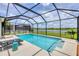 Sparkling pool featuring a screened enclosure and lovely views of the lake and backyard at 7930 111Th Ter E, Parrish, FL 34219