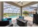 Wonderful outdoor area with a pool, firepit, comfortable seating and a beautiful landscape view at 7930 111Th Ter E, Parrish, FL 34219