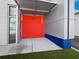 Eye-level photo of an industrial building entrance with a bright red accent wall and clear glass doors at 8100 Ciboney Ct # 10, Sarasota, FL 34240
