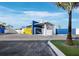 Stylish building exterior with covered parking featuring a yellow gate, set against a backdrop of blue and white accents at 8100 Ciboney Ct # 10, Sarasota, FL 34240