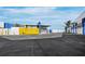 Property with a yellow gate and covered parking, showcasing a modern design with a mix of textures and open space at 8100 Ciboney Ct # 10, Sarasota, FL 34240