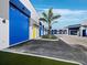 Modern blue and white storage units with colorful doors offer ample space, enhanced by landscaping with palm trees at 8100 Ciboney Ct # 10, Sarasota, FL 34240