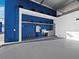 Spacious industrial interior with a wash basin, grey cabinets, white walls and bright blue accents at 8100 Ciboney Ct # 10, Sarasota, FL 34240