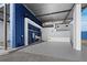 Industrial space featuring blue accents, overhead lighting, a wash basin and roll-up doors at 8100 Ciboney Ct # 10, Sarasota, FL 34240