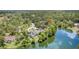 The house sits near the lake, surrounded by lush green trees at 9007 63Rd Avenue E Dr, Bradenton, FL 34202