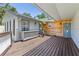 Inviting back porch with wooden deck, gray siding, and charming wood accents at 9007 63Rd Avenue E Dr, Bradenton, FL 34202