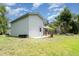Spacious backyard with lush green grass, shed, and screened pool in the distance at 9007 63Rd Avenue E Dr, Bradenton, FL 34202