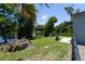 A scenic backyard featuring a serene lake, a fire pit, and lush green grass at 9007 63Rd Avenue E Dr, Bradenton, FL 34202