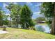 Picturesque backyard featuring lush greenery and a serene lakeside view at 9007 63Rd Avenue E Dr, Bradenton, FL 34202