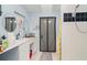 Bathroom featuring double vanity and a bright shower with black-and-white accents at 9007 63Rd Avenue E Dr, Bradenton, FL 34202