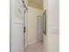 Hallway view of bathroom, featuring a modern farmhouse style sliding door at 9007 63Rd Avenue E Dr, Bradenton, FL 34202