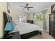 Primary bedroom with dark furniture set and a view into the sunroom at 9007 63Rd Avenue E Dr, Bradenton, FL 34202