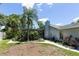 A serene backyard, featuring a sunroom, palm trees and beautiful landscaping at 9007 63Rd Avenue E Dr, Bradenton, FL 34202