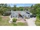 Charming single-Gathering home featuring a well-manicured lawn, garden beds, and a quaint front porch at 9007 63Rd Avenue E Dr, Bradenton, FL 34202