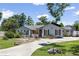 Charming single-story home with a well-manicured lawn, rock walls, and a paved driveway at 9007 63Rd Avenue E Dr, Bradenton, FL 34202