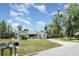 Single-story home featuring manicured lawn, mature trees and a long driveway at 9007 63Rd Avenue E Dr, Bradenton, FL 34202