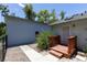 An exterior view of a home features a backyard entrance with a small wood deck at 9007 63Rd Avenue E Dr, Bradenton, FL 34202