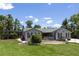 A sprawling single-story home with a well-maintained lawn and mature trees at 9007 63Rd Avenue E Dr, Bradenton, FL 34202