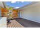 Inviting front porch with a wood accent wall, a door with lovely decorations, and stylish decor at 9007 63Rd Avenue E Dr, Bradenton, FL 34202