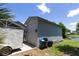 Detached garage with a white door, blue siding, and a trailer alongside at 9007 63Rd Avenue E Dr, Bradenton, FL 34202