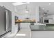 Modern kitchen with white cabinets, stainless steel appliances, and tile backsplash at 9007 63Rd Avenue E Dr, Bradenton, FL 34202