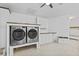 Laundry room with front load washer and dryer and built-in cabinetry at 9007 63Rd Avenue E Dr, Bradenton, FL 34202