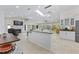 Bright living room featuring tile floors, modern lighting, fireplace, and plenty of natural light at 9007 63Rd Avenue E Dr, Bradenton, FL 34202