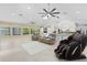 Bright open-concept living room with tile floors, large windows, and comfortable seating at 9007 63Rd Avenue E Dr, Bradenton, FL 34202