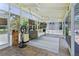 Enclosed patio featuring brick floors, a swing bed, and views of the lush greenery at 9007 63Rd Avenue E Dr, Bradenton, FL 34202