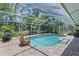 Screen-enclosed outdoor pool with brick patio, chair, and clear blue water at 9007 63Rd Avenue E Dr, Bradenton, FL 34202