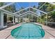 Screened-in pool area with lush landscaping and outdoor seating, perfect for relaxation at 9007 63Rd Avenue E Dr, Bradenton, FL 34202