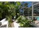 Backyard view of the screen enclosed patio, pool area and verdant landscaped yard at 9007 63Rd Avenue E Dr, Bradenton, FL 34202
