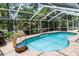 Sparkling pool area enclosed with a screen and chair at 9007 63Rd Avenue E Dr, Bradenton, FL 34202