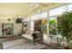 Relaxing screened porch with comfortable swing, ceiling fans, and view of the lush backyard at 9007 63Rd Avenue E Dr, Bradenton, FL 34202