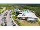 An aerial view of the community pool and clubhouse surrounded by lush landscaping and green spaces at 10254 Morning Mist Ln, Sarasota, FL 34241