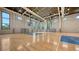Full indoor basketball court with gleaming hardwood floor and natural light at 10254 Morning Mist Ln, Sarasota, FL 34241