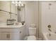 Well-lit bathroom featuring white vanity, sink, and shower with a decorative shower niche at 10254 Morning Mist Ln, Sarasota, FL 34241