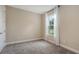 Bedroom featuring neutral carpet, window with sheer curtains, and ample natural light at 10254 Morning Mist Ln, Sarasota, FL 34241