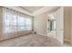 Bright bedroom featuring large windows, neutral walls, and carpet flooring at 10254 Morning Mist Ln, Sarasota, FL 34241