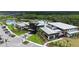 Aerial view of a modern community center with a pool, gym, and beautifully landscaped grounds in a residential area at 10254 Morning Mist Ln, Sarasota, FL 34241