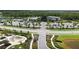 Aerial view of the community center featuring ample parking and a landscaped entry with palm trees and lush plants at 10254 Morning Mist Ln, Sarasota, FL 34241