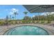Relaxing hot tub surrounded by lounge chairs and lush landscaping for a serene outdoor experience at 10254 Morning Mist Ln, Sarasota, FL 34241