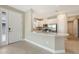 Open kitchen with a breakfast bar, white cabinets, and stainless steel appliances at 10254 Morning Mist Ln, Sarasota, FL 34241