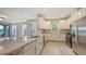 Gourmet kitchen features stainless steel appliances and white cabinets, perfect for entertaining at 10254 Morning Mist Ln, Sarasota, FL 34241