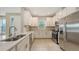 Modern kitchen with stainless steel appliances, white cabinetry, and tile backsplash at 10254 Morning Mist Ln, Sarasota, FL 34241