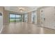 Bright living room with tile flooring, large windows overlooking the lake and tray ceiling at 10254 Morning Mist Ln, Sarasota, FL 34241