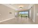 Open-concept living room with chandelier and sliding glass doors to the patio at 10254 Morning Mist Ln, Sarasota, FL 34241