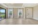 Bright living room with tile flooring, large windows overlooking the lake at 10254 Morning Mist Ln, Sarasota, FL 34241