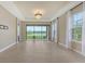 Open-concept living room with chandelier and sliding glass doors to the patio at 10254 Morning Mist Ln, Sarasota, FL 34241