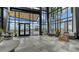 Modern lobby with high ceilings, comfortable seating, and large windows showcasing lush landscaping and natural light at 10254 Morning Mist Ln, Sarasota, FL 34241